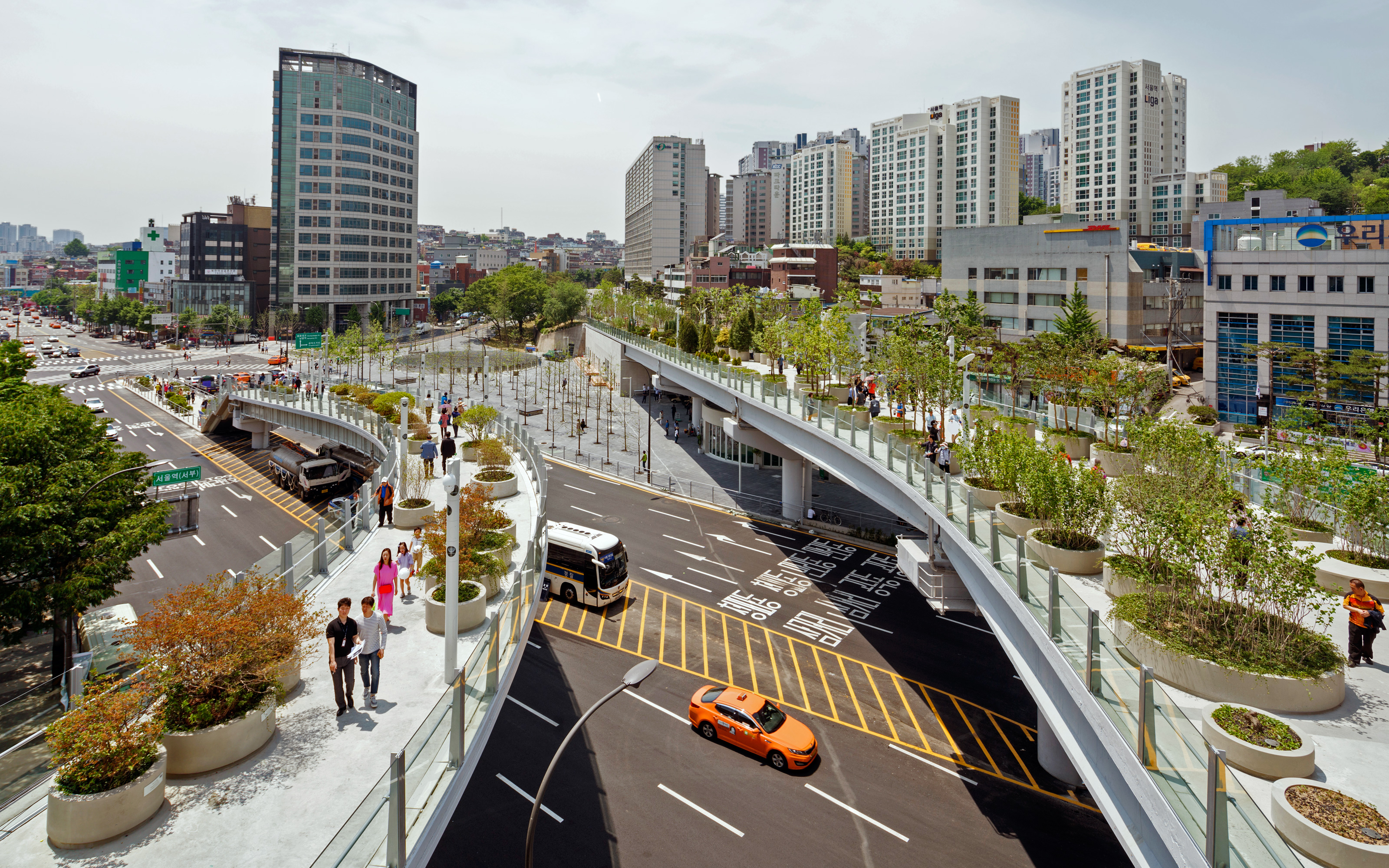 People strolling on a large roof garden in the city